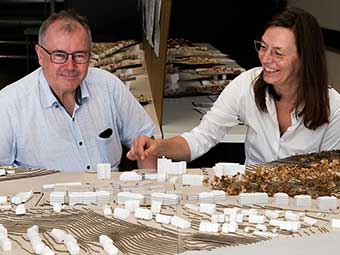 Prof. Anja Ohliger (rechts), Studiengangsleiterin Architektur, zeigt Dekan Prof. Dr. Egbert Keßler (links) im Modell ein Wohngebiet im Coburger Stadtteil Wüstenahorn. 